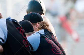High school baseball team in dugout.