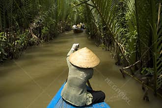 Vietnamese woman rowing a boat