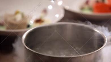 Making ice cream with cold liquid. Beautiful evaporation from liquid nitrogen. Ice cream. The boiling nitrogen