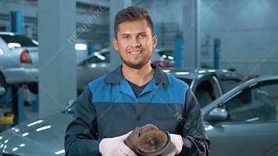 Portrait of Professional smiling car mechanic working in modern auto repair service