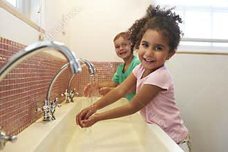 Pupils At Montessori School Washing Hands In Washroom