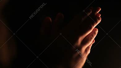 Couple is holding hands near campfire at night. Party with bonfire with friends