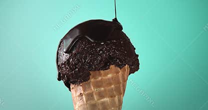 Chocolate ice cream corn and liquid chocolate falling on it