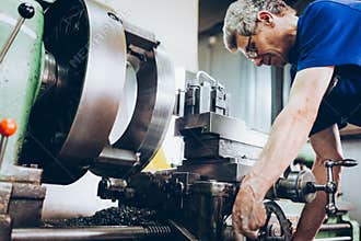 Industrial factory employee working in metal manufacturing industry