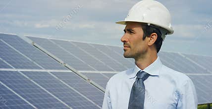 Engineer expert in solar energy photovoltaic panels with remote control performs routine actions for system monitoring using clean