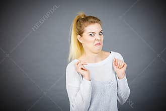 Disgusted woman having funny face expression