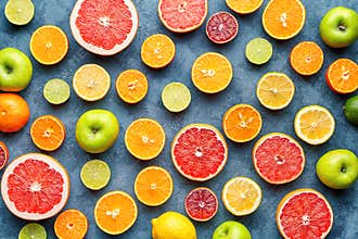 Citrus fruit pattern on grey concrete table. Food background. Healthy eating. Antioxidant, detox, dieting, clean eating