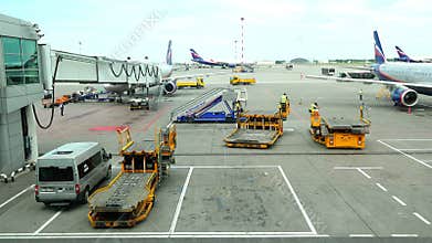 Truck rack containers sent to the airport parking lot to the next board aircraft `Aeroflot` airlines