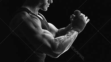 Black and white photo of strong hands and fist, ready for training and active exercise Strong man wrap hands Man is wrapping hand