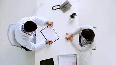 Doctor with diet plan and patient at hospital