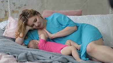 Affectionate mother breastfeeding her baby girl