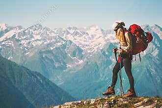 Girl Traveler hiking with backpack at rocky mountains