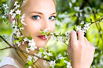 Woman by flowers on tree