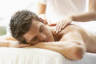 Young Man Enjoying Massage At Spa
