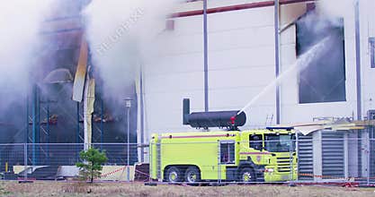 Firetruck trying to get control over a fire in industrial building