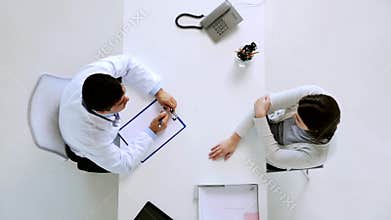 Doctor with clipboard and patient at hospital