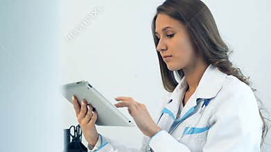 Female doctor using tablet computer in medical office