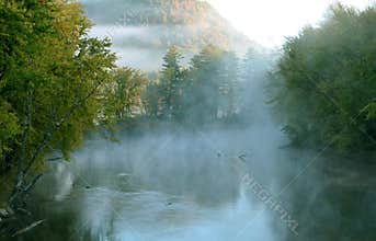 Beautiful Fog covered Swift river with Distant Mountain