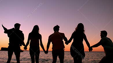 Friends jumping at the beach
