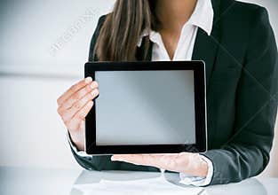 Businesswoman displaying a blank tablet