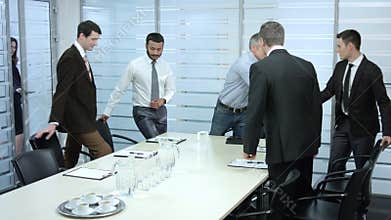 Secretary comes in a meeting room.