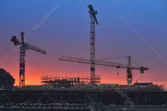Building under construction at sunset. Night scenes