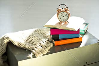 Bedtime reading, alarm clock and books