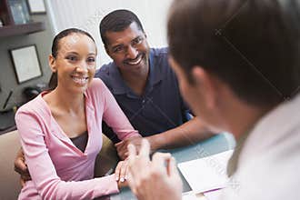 Couple in discussion with doctor in IVF clinic
