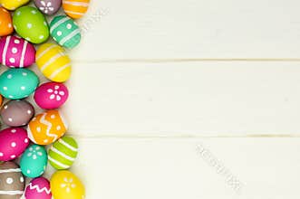 Easter egg side border against white wood