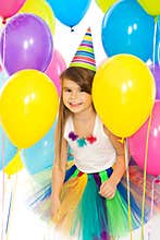 Happy little kid girl with colorful balloons on
