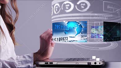 Woman using laptop with business hologram interface