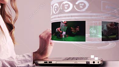 Woman using laptop with gambling holographic interface