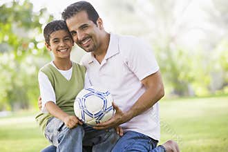 Father and son playing football