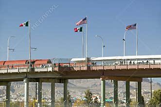 International border of Mexico & the United States, with flags and walking bridge connecting El Paso Texas to Juarez, Mexico