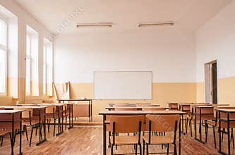 Empty classroom with wooden desks