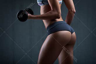 Very beautiful in thong. Fitness woman with dumbbells