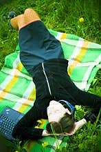 Girl relaxing on blanket outdoors