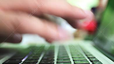 Human hands typing on computer keyboard