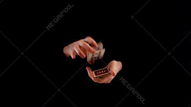 Unusual playing card trick on black background