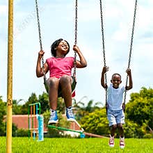 African kids having fun swinging in park.