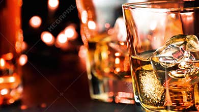 Pouring whiskey on bar table near bottles warm atmosphere
