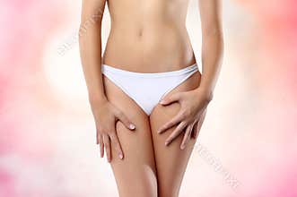 Woman abdomen on pink background