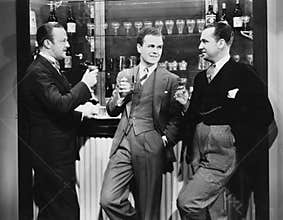 Businessmen drinking together at bar