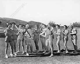 Group of women holding baseball bats and standing in a row