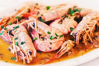 Platter full of shrimp served with parsley