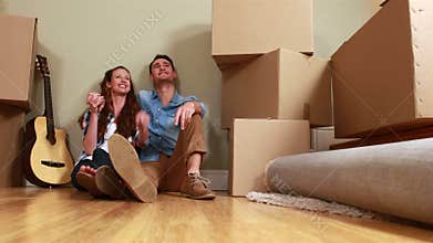 Attractive young couple unpacking boxes