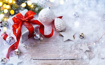 Art Christmas gift boxes on snow background and holidays light