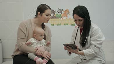 Female pediatrician doctor shows something on