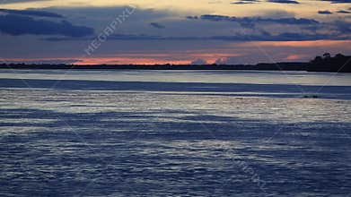 Colorful sunset on the river Amazon in the rainforest, Brazil