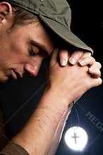 Praying Man Holding A Cross